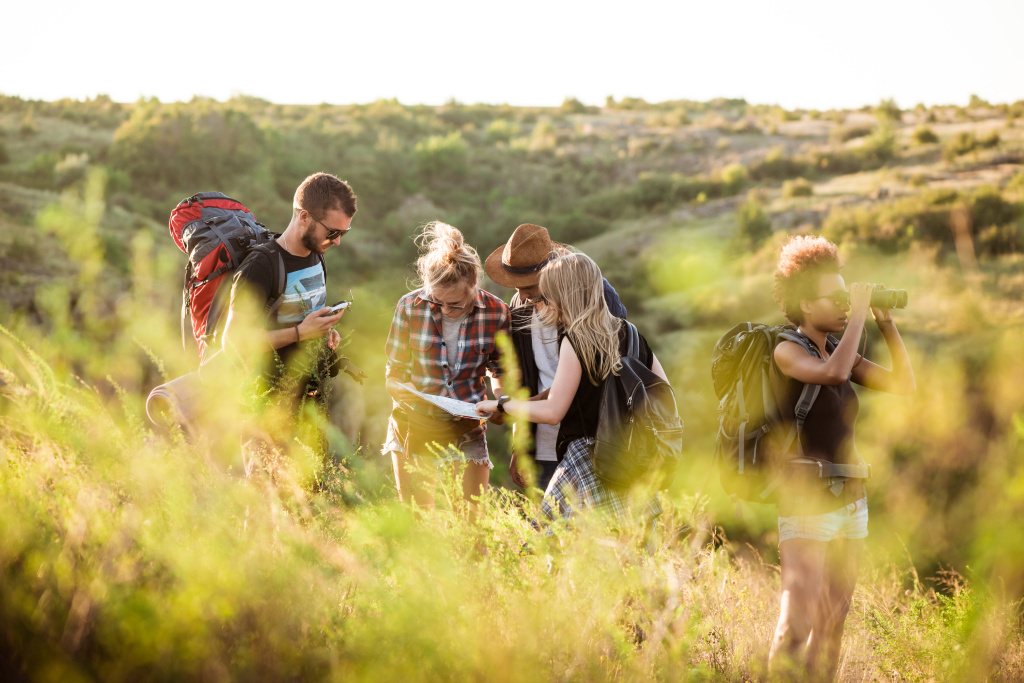young-friends-with-backpacks-enjoying-view-traveling-canyon.jpg
