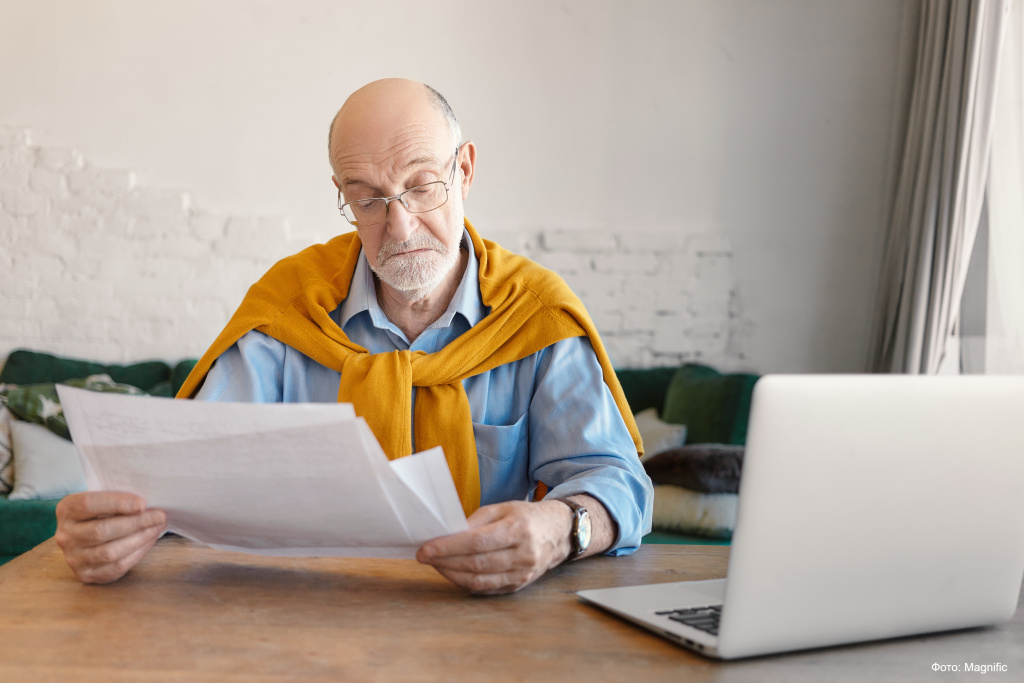 elegant-bearded-elderly-man-rectangular-glasses-studying-paper-sheets-his-hands-calculating-domestic-finances-online-home-using-electronic-portable-device-living-room-interior (1).jpg